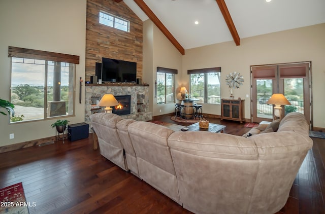 living area with beam ceiling, a fireplace, dark wood-type flooring, high vaulted ceiling, and baseboards