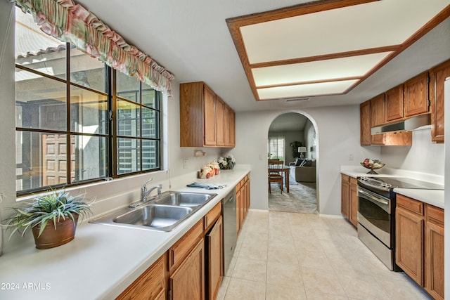 kitchen featuring appliances with stainless steel finishes, light tile patterned flooring, and sink