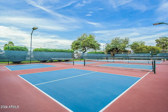 view of tennis court with basketball hoop