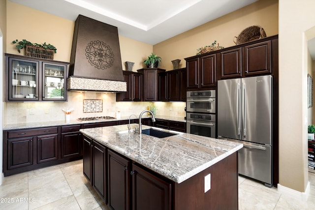 12904 W Dale Ln, Peoria, AZ 85383 - kitchen with appliances with stainless steel finishes, a sink, premium range hood, tasteful backsplash, and light stone counters