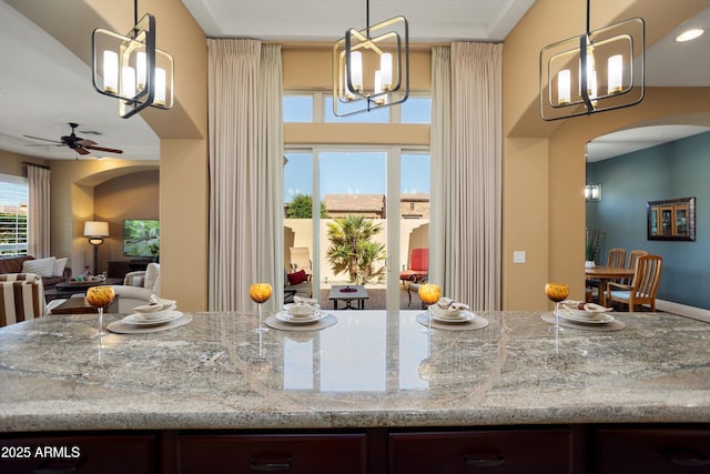 12904 W Dale Ln, Peoria, AZ 85383 - kitchen featuring arched walkways, a chandelier, ceiling fan, open floor plan, and decorative light fixtures