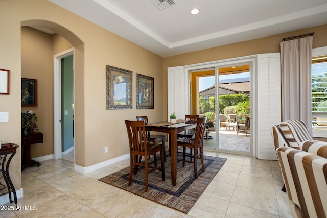 12904 W Dale Ln, Peoria, AZ 85383 - dining space featuring healthy amount of natural light, arched walkways, baseboards, light tile patterned floors, and recessed lighting