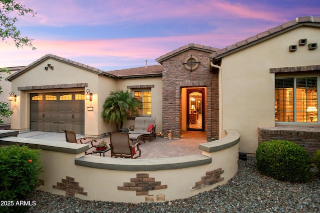 12904 W Dale Ln, Peoria, AZ 85383 - view of front of property featuring stucco siding, stone siding, and an attached garage