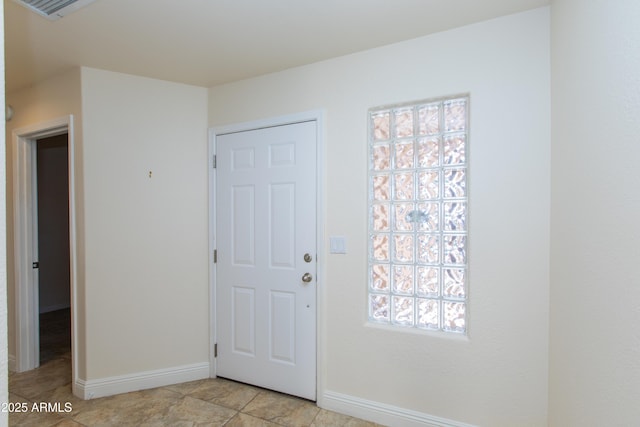 entryway with baseboards and visible vents