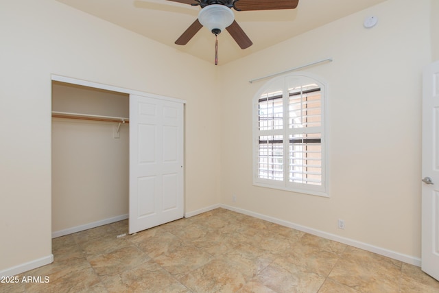 unfurnished bedroom with a ceiling fan, baseboards, and a closet