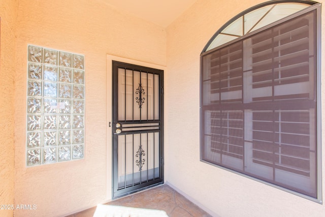 property entrance with stucco siding