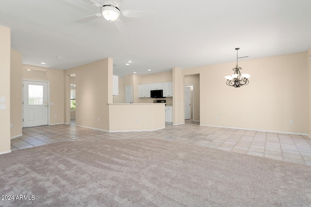 unfurnished living room with light tile flooring and ceiling fan with notable chandelier