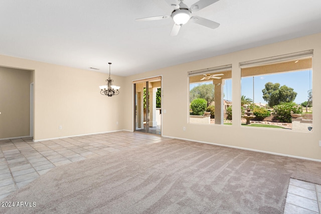 empty room with light colored carpet and ceiling fan with notable chandelier