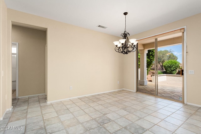 tiled empty room with a notable chandelier