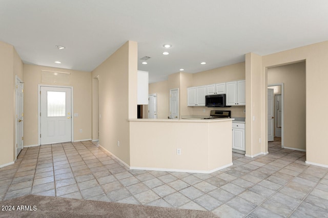 kitchen featuring white cabinets, kitchen peninsula, light tile floors, and range