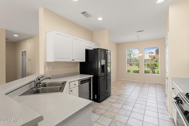 kitchen featuring sink, light tile flooring, white cabinetry, and stainless steel appliances