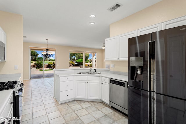 kitchen featuring decorative light fixtures, white cabinets, light tile flooring, kitchen peninsula, and appliances with stainless steel finishes