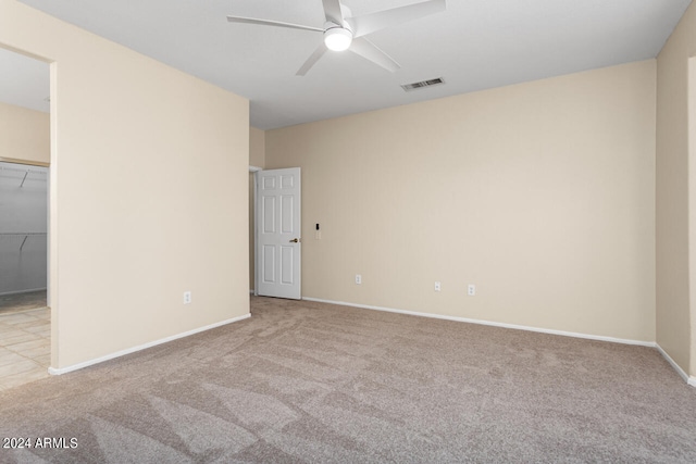 unfurnished room featuring ceiling fan and light carpet