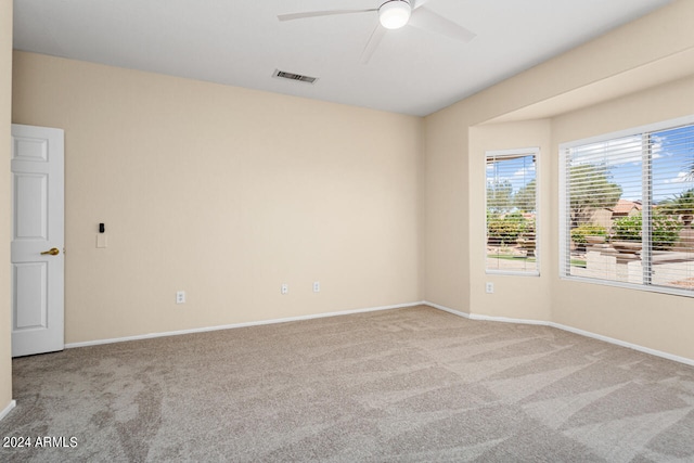 empty room with ceiling fan and carpet