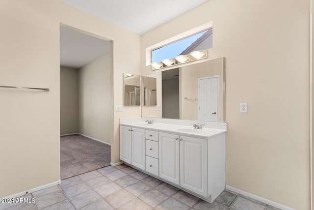 bathroom with double vanity and tile floors