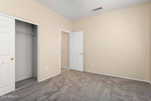 unfurnished bedroom with a closet and carpet