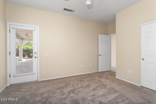 spare room featuring ceiling fan and carpet floors