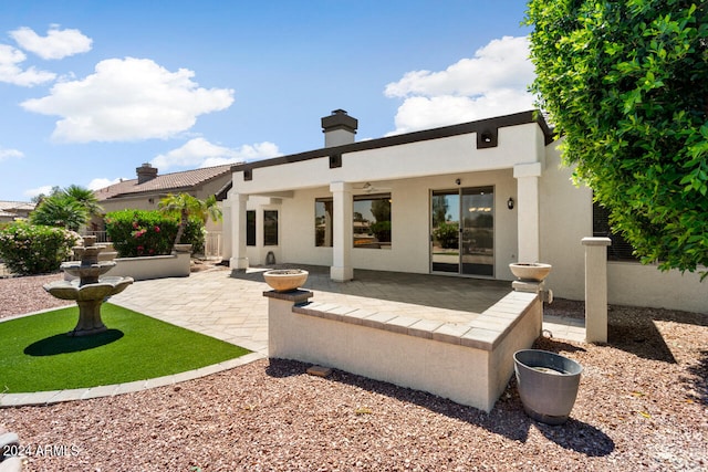 rear view of property featuring a patio