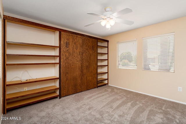 unfurnished bedroom with ceiling fan and carpet