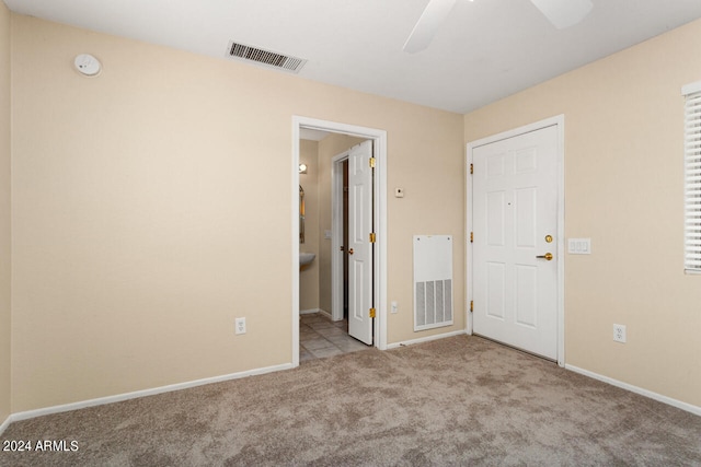 unfurnished room with ceiling fan and light carpet