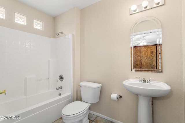 bathroom with toilet, tile floors, and shower / tub combination