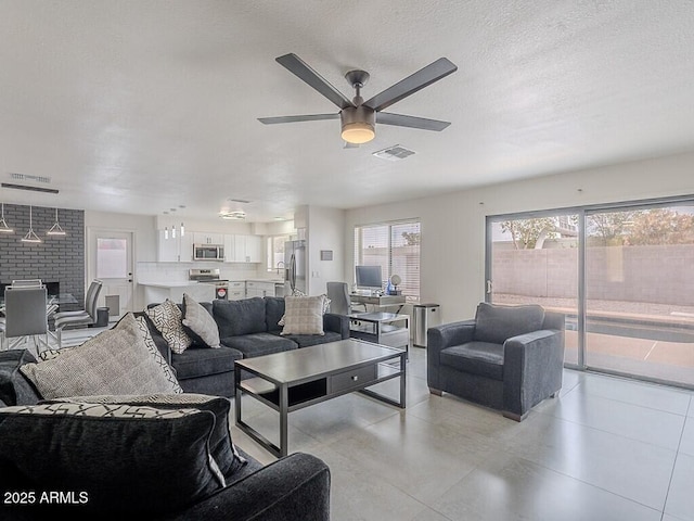 5817 S Siesta Ln, Tempe, AZ 85283 - living area featuring a ceiling fan, light tile patterned flooring, and a textured ceiling