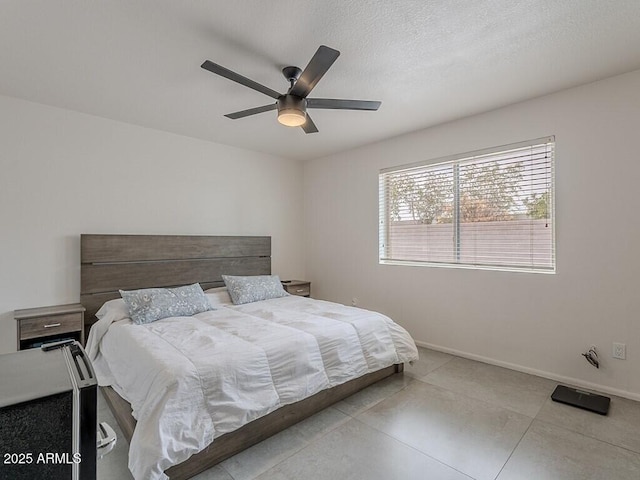 5817 S Siesta Ln, Tempe, AZ 85283 - bedroom featuring ceiling fan, baseboards, and a textured ceiling
