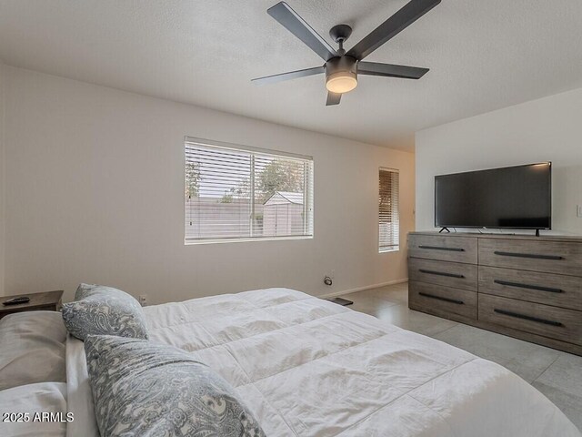 5817 S Siesta Ln, Tempe, AZ 85283 - bedroom featuring a ceiling fan, baseboards, and a textured ceiling