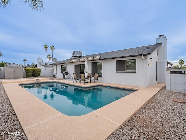5817 S Siesta Ln, Tempe, AZ 85283 - back of property with a patio, a chimney, a fenced backyard, central air condition unit, and a shingled roof