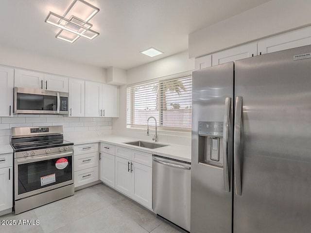 5817 S Siesta Ln, Tempe, AZ 85283 - kitchen with stainless steel appliances, a sink, light countertops, and white cabinets