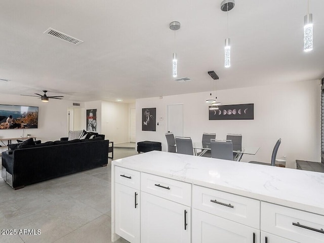 5817 S Siesta Ln, Tempe, AZ 85283 - kitchen featuring open floor plan, a ceiling fan, white cabinets, and pendant lighting