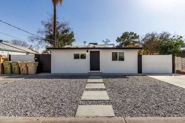 single story home featuring fence and stucco siding