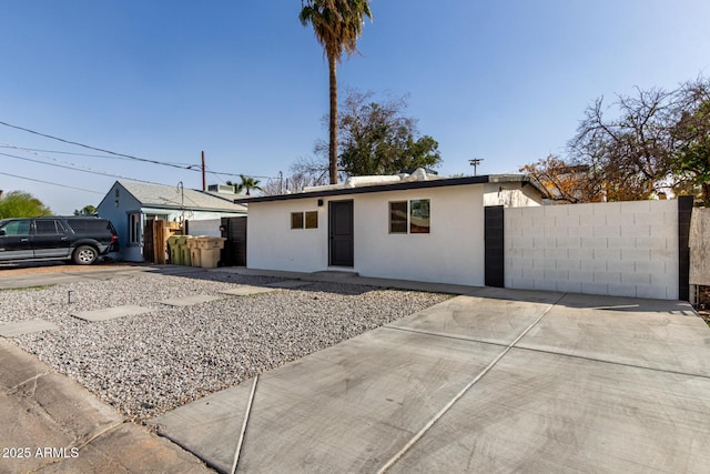 single story home with fence and stucco siding