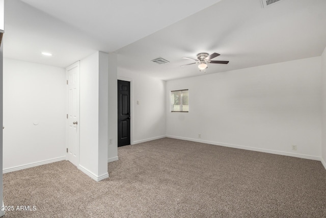 unfurnished room featuring baseboards, visible vents, ceiling fan, and light colored carpet