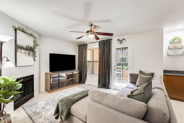 living room with light tile patterned floors and ceiling fan