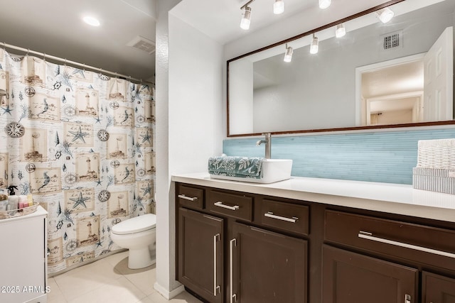 bathroom featuring visible vents, toilet, vanity, and tile patterned floors