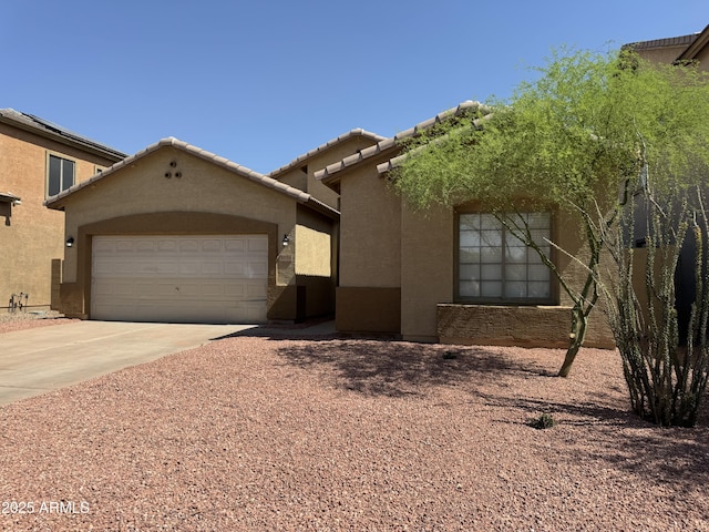 9224 W Raymond St, Tolleson, AZ 85353 - view of front of home featuring driveway, stucco siding, and a garage