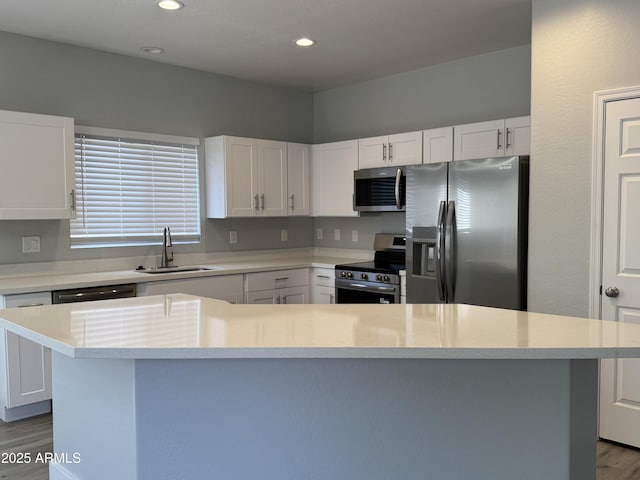 9224 W Raymond St, Tolleson, AZ 85353 - kitchen with appliances with stainless steel finishes, wood finished floors, light countertops, white cabinetry, and recessed lighting