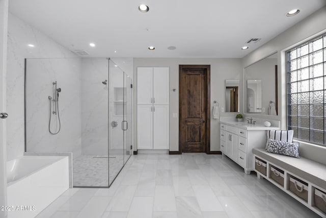 bathroom with vanity and separate shower and tub