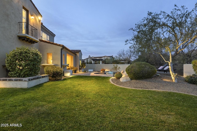 yard at dusk with a patio