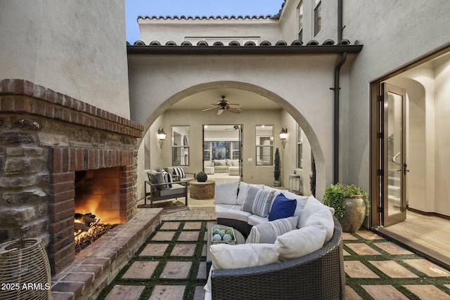 view of patio featuring an outdoor living space with a fireplace