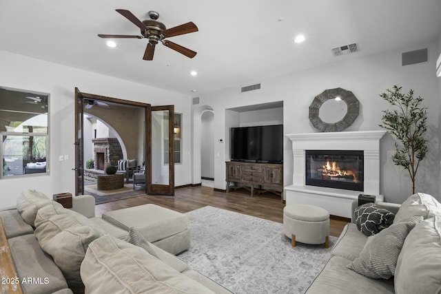 living room with hardwood / wood-style floors and ceiling fan