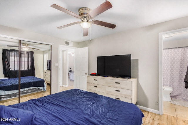 bedroom with ceiling fan, a closet, ensuite bathroom, and light hardwood / wood-style floors