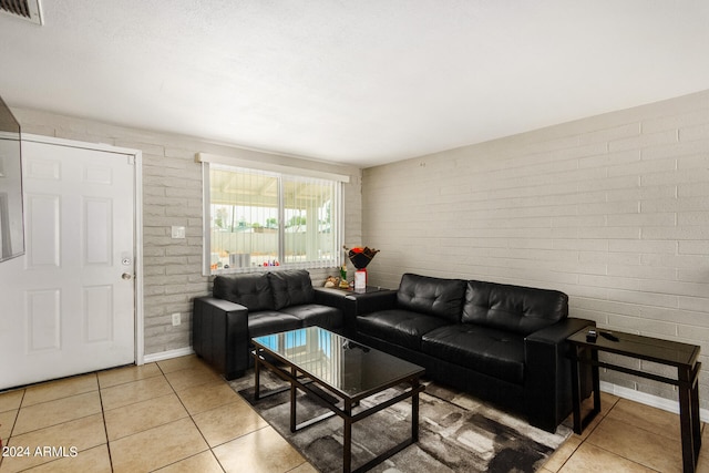 tiled living room with brick wall