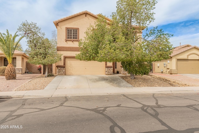 view of front of property featuring stucco siding, driveway, a tile roof, stone siding, and a garage