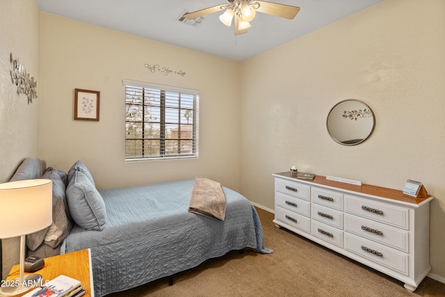 carpeted bedroom featuring a ceiling fan and visible vents