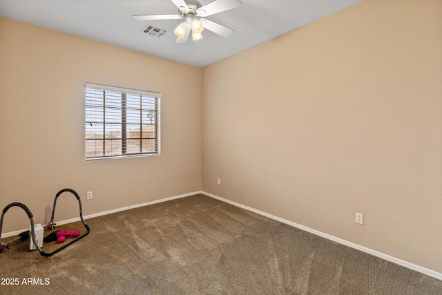 empty room featuring visible vents, carpet floors, baseboards, and a ceiling fan