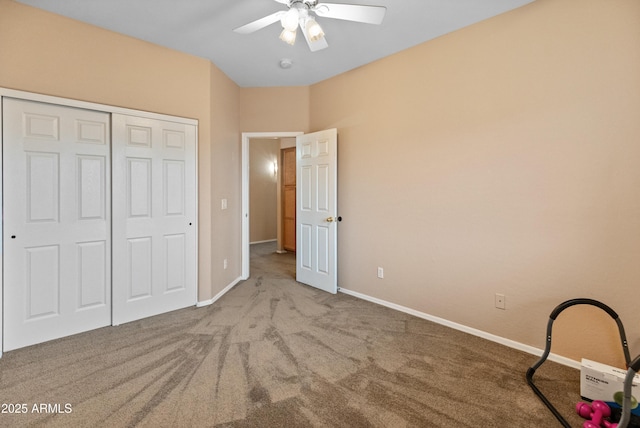 unfurnished bedroom featuring ceiling fan, carpet, a closet, and baseboards