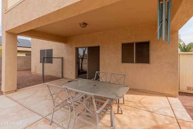 view of patio with outdoor dining space and fence