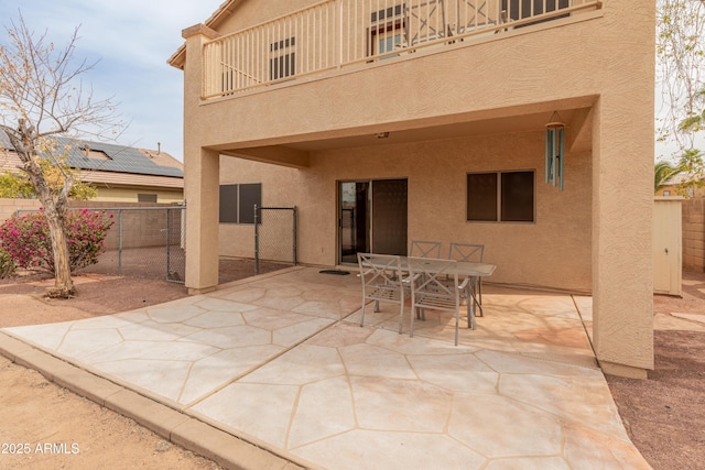 view of patio / terrace with outdoor dining space, a balcony, and fence